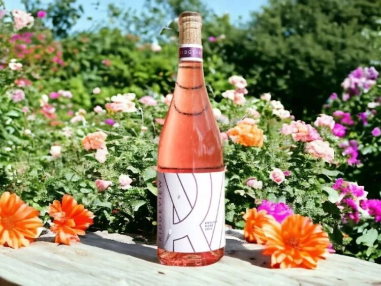 Ridgeview English Rosé Wine on a table surrounded by colourful flowers on the Ridgeview Estate