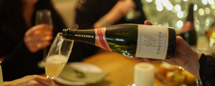 Fitzrovia Rose being poured into glass infront of Christmas tree