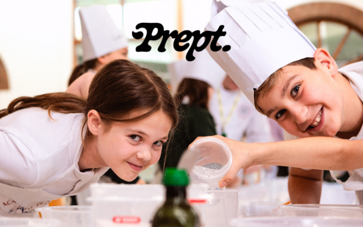 Two children cooking, the boy has a chefs hat one and they are both grinning. The Prept logo is overlaid.